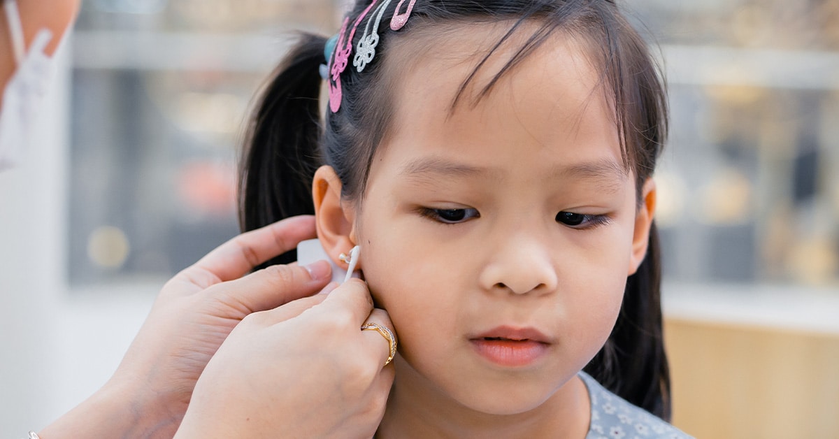 Toddler getting her ear pierced at Urgent Care for Children
