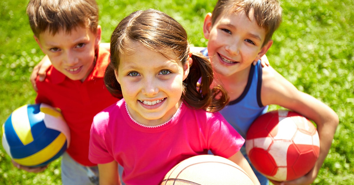 children holding balls after being examined by Urgent Care for Children