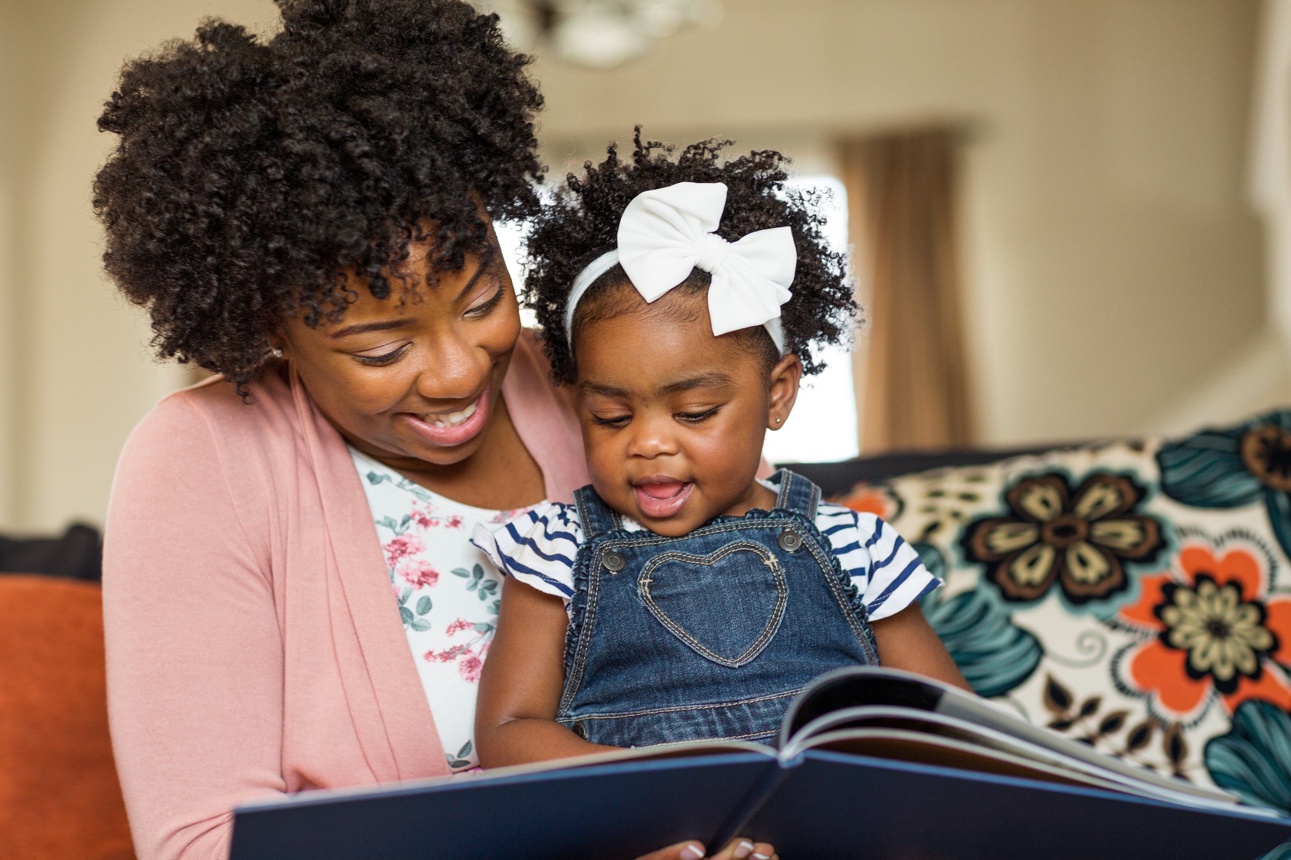 Mother and daughter reading a book together at Urgent Care for Children