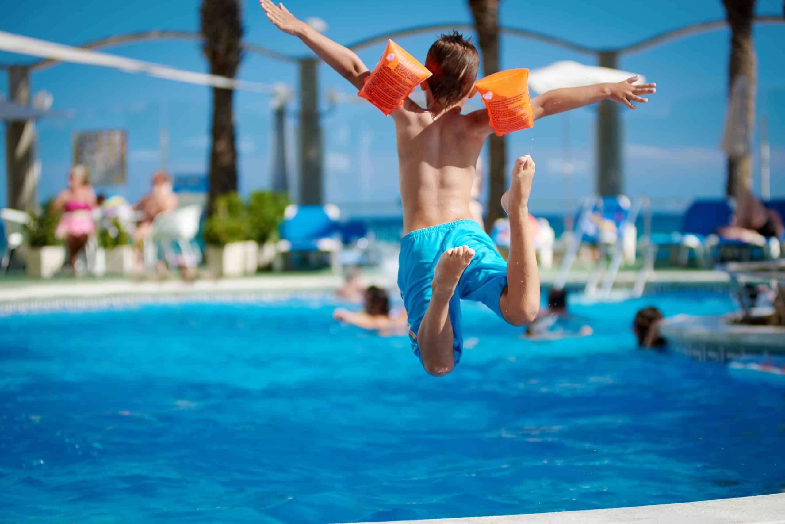 kid jumping into a pool after a check up at Urgent Care for Children