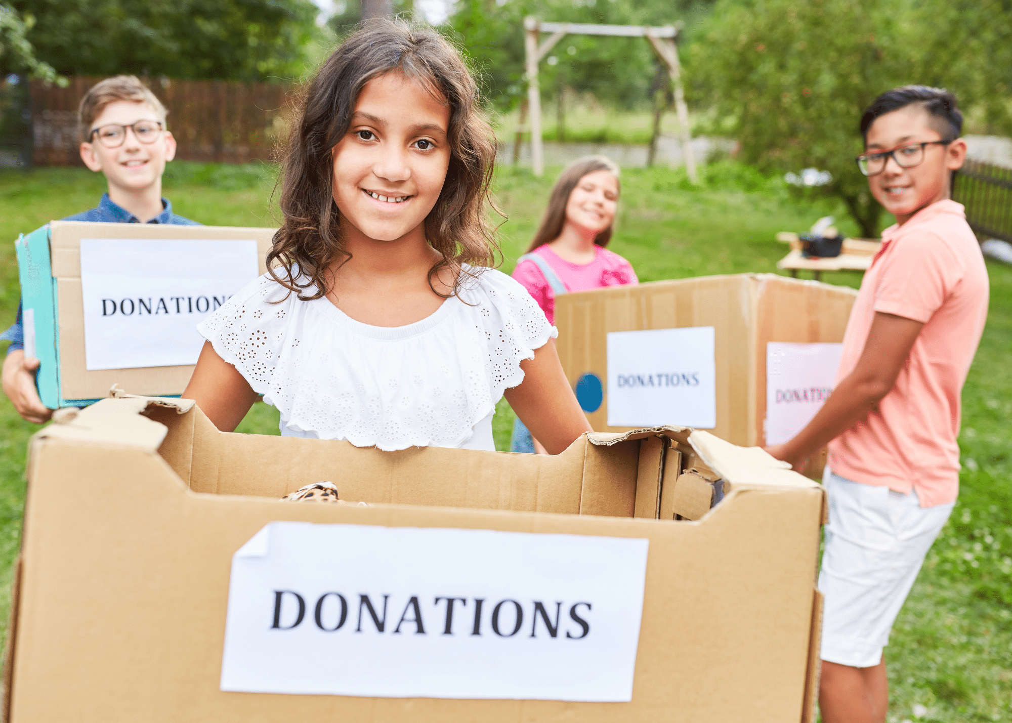 Children volunteering, holding a donation box